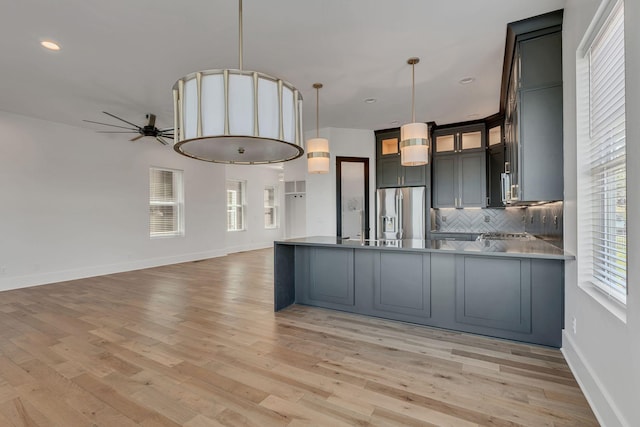 418 Mercomatic Dr, Nashville, TN 37209 - kitchen with stainless steel fridge, ceiling fan, a peninsula, tasteful backsplash, and light wood-style flooring