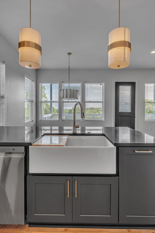 418 Mercomatic Dr, Nashville, TN 37209 - kitchen featuring dishwasher, a sink, gray cabinets, pendant lighting, and dark stone countertops