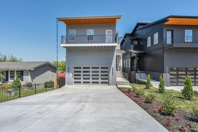 418 Mercomatic Dr, Nashville, TN 37209 - contemporary home featuring brick siding, fence, driveway, a balcony, and a garage
