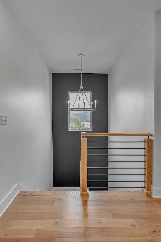 418 Mercomatic Dr, Nashville, TN 37209 - empty room with a chandelier, baseboards, and wood finished floors