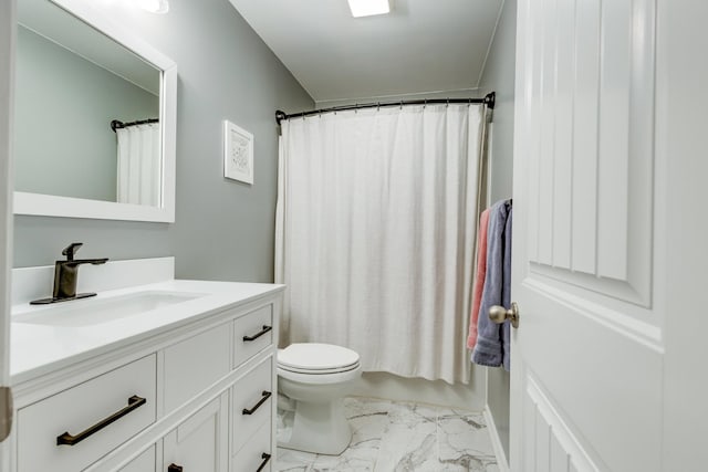 bathroom with a shower with shower curtain, marble finish floor, vanity, and toilet