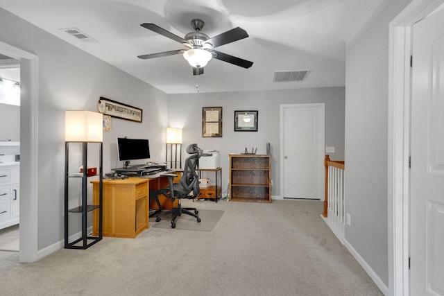 office with visible vents, light colored carpet, and ceiling fan