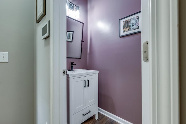 bathroom featuring baseboards, vanity, and wood finished floors