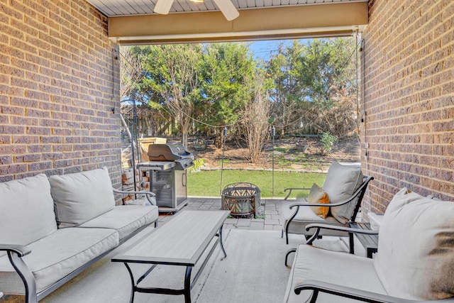 view of patio / terrace featuring a ceiling fan, an outdoor living space with a fire pit, and a grill