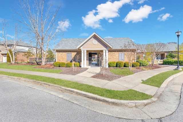 bungalow-style house with fence private yard, a gate, and brick siding