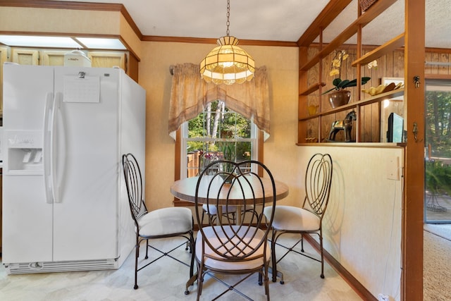 dining space featuring plenty of natural light and crown molding