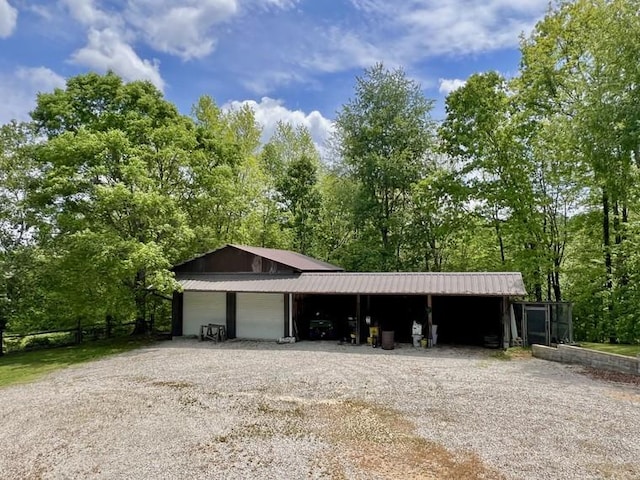 5199 Nelson Rd, Westpoint, TN 38486 - garage featuring fence and gravel driveway