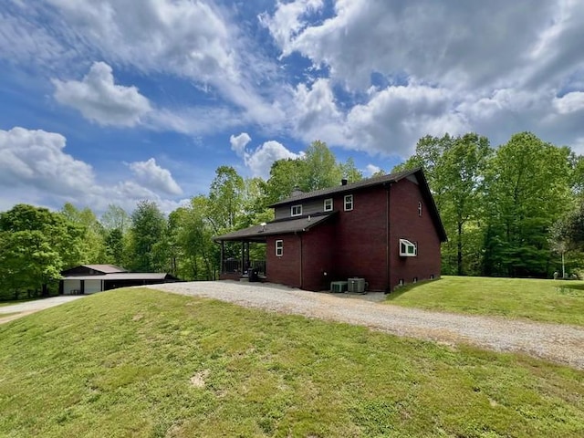 5199 Nelson Rd, Westpoint, TN 38486 - view of side of home featuring brick siding, central air condition unit, a yard, and driveway
