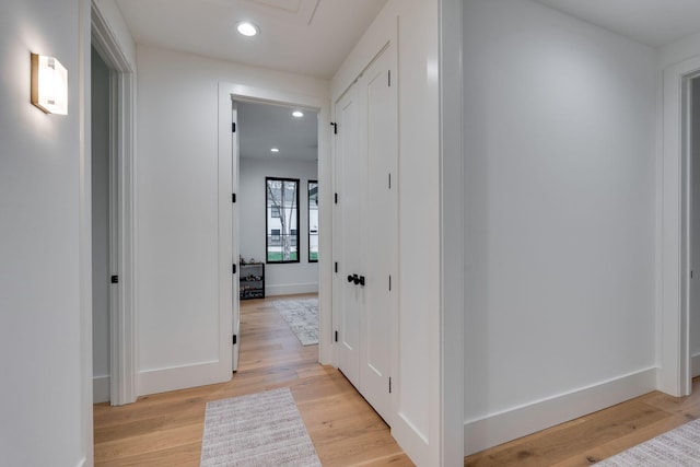 corridor with recessed lighting, light wood-style flooring, and baseboards