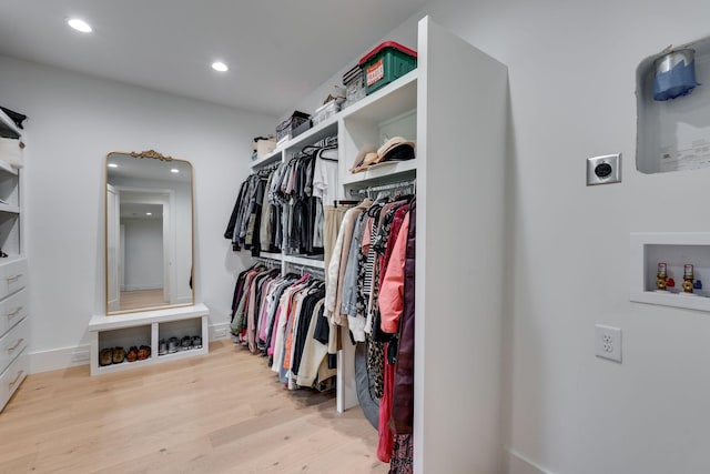walk in closet featuring wood finished floors