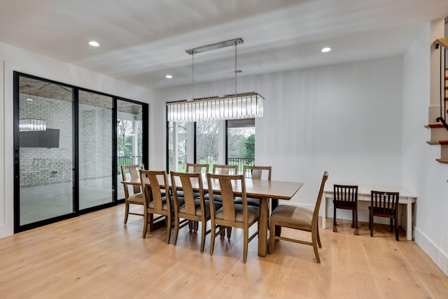 dining room with recessed lighting and light wood-style flooring