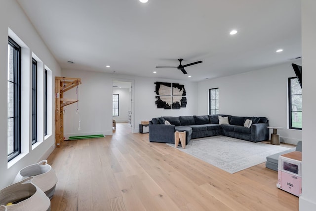 living area featuring light wood-style floors, ceiling fan, baseboards, visible vents, and recessed lighting