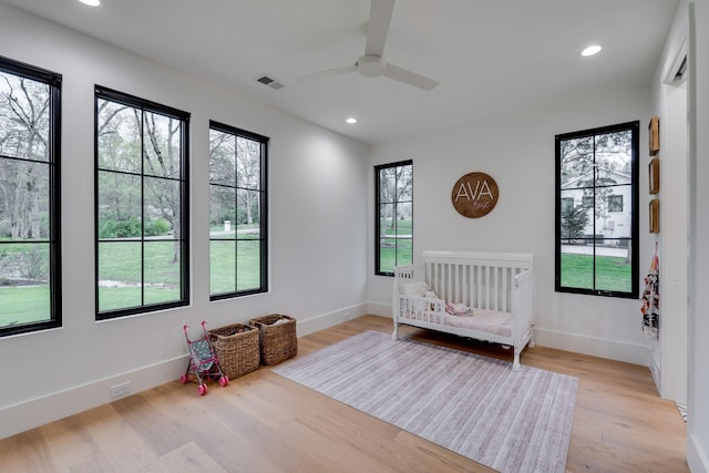 bedroom featuring light wood-style flooring, visible vents, recessed lighting, and multiple windows