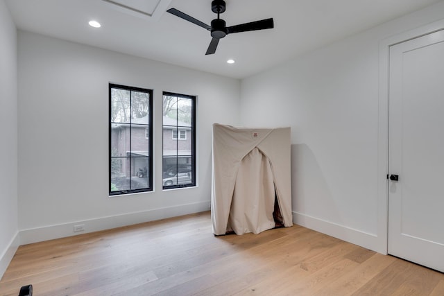 spare room featuring baseboards, a ceiling fan, light wood-style floors, and recessed lighting
