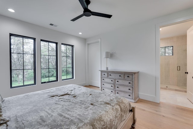 bedroom featuring recessed lighting, visible vents, light wood-style floors, baseboards, and ensuite bathroom