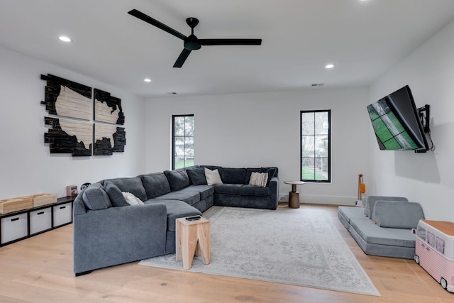 living area with ceiling fan, a healthy amount of sunlight, wood finished floors, and recessed lighting