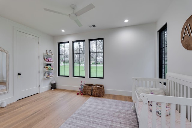 bedroom with baseboards, light wood-style flooring, visible vents, and recessed lighting