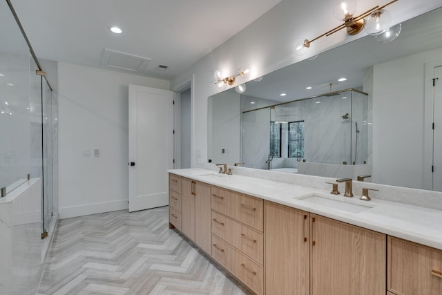 full bathroom featuring double vanity, baseboards, a marble finish shower, and a sink