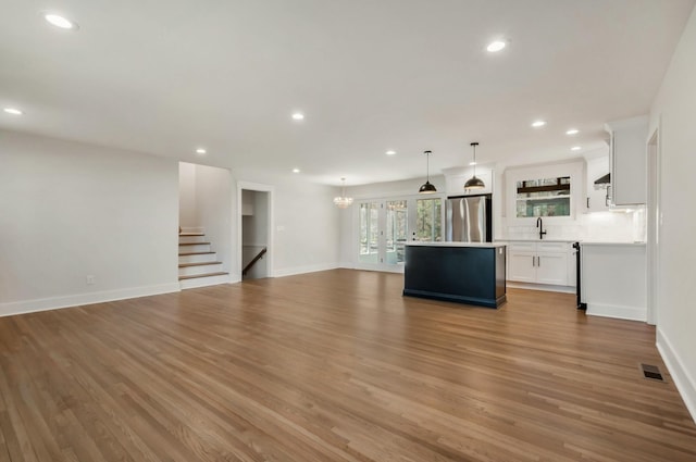 931 Downey Dr, Nashville, TN 37205 - unfurnished living room with wood finished floors, visible vents, a sink, and recessed lighting