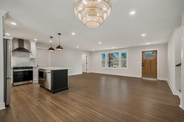 931 Downey Dr, Nashville, TN 37205 - kitchen featuring decorative backsplash, wall chimney range hood, light countertops, dark wood-type flooring, and appliances with stainless steel finishes