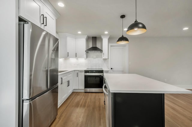 931 Downey Dr, Nashville, TN 37205 - kitchen with a center island, light wood-type flooring, stainless steel appliances, light countertops, and wall chimney exhaust hood