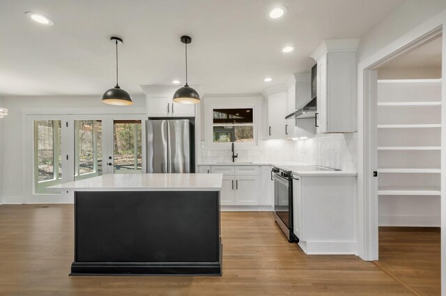 931 Downey Dr, Nashville, TN 37205 - kitchen with light countertops, wall chimney range hood, decorative backsplash, and stainless steel appliances