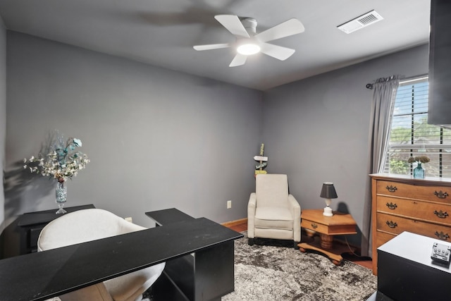 office featuring wood finished floors, visible vents, baseboards, and ceiling fan