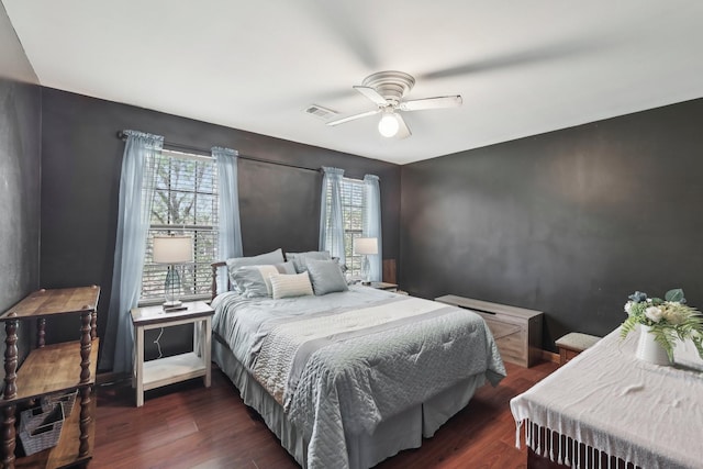 bedroom featuring wood finished floors, visible vents, ceiling fan, and multiple windows