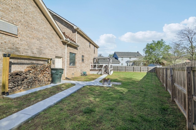 view of yard with a fenced backyard and a deck
