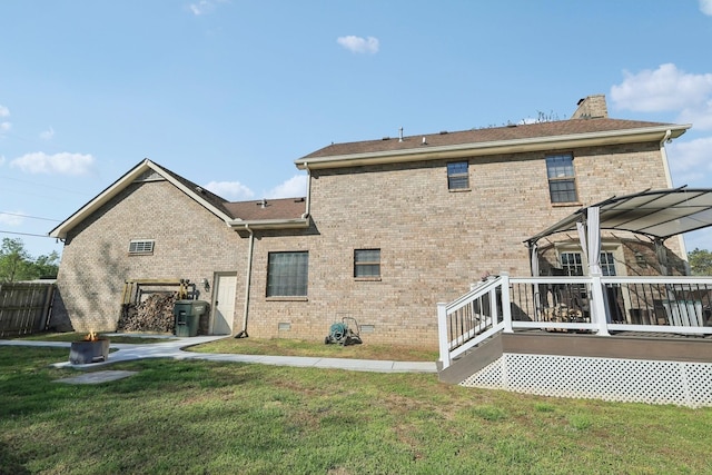 rear view of house with a lawn, a chimney, crawl space, and a deck