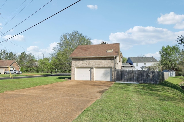 view of side of property with fence, concrete driveway, a yard, and a garage