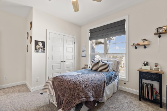 bedroom featuring a closet, carpet flooring, baseboards, and a ceiling fan