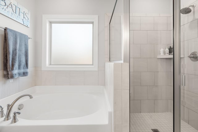 bathroom featuring a garden tub and a stall shower