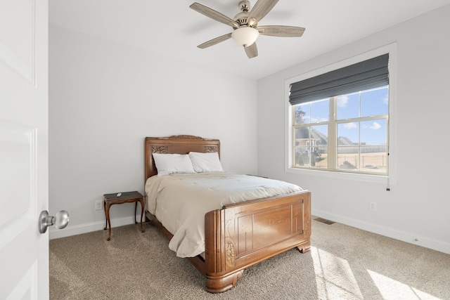 bedroom featuring carpet floors, visible vents, baseboards, and ceiling fan