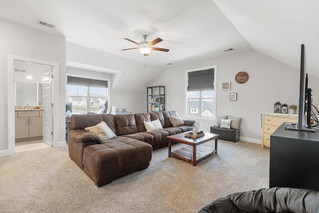 living area with lofted ceiling, light carpet, visible vents, and ceiling fan