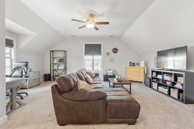 living area featuring lofted ceiling, visible vents, carpet floors, and ceiling fan