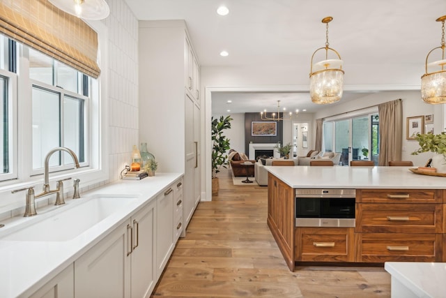 6490 Peytonsville Arno Rd, College Grove, TN 37046 - kitchen with stainless steel oven, a sink, light wood finished floors, and recessed lighting