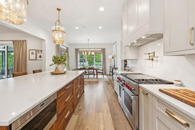 6490 Peytonsville Arno Rd, College Grove, TN 37046 - kitchen with recessed lighting, white cabinets, double oven range, a chandelier, and light wood-style flooring
