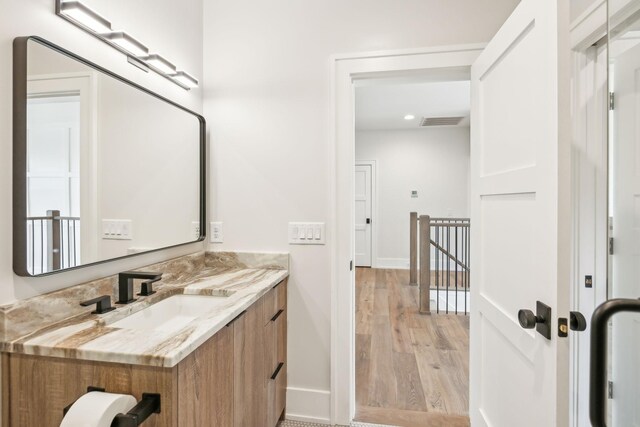 6490 Peytonsville Arno Rd, College Grove, TN 37046 - bathroom featuring wood finished floors, vanity, baseboards, visible vents, and recessed lighting
