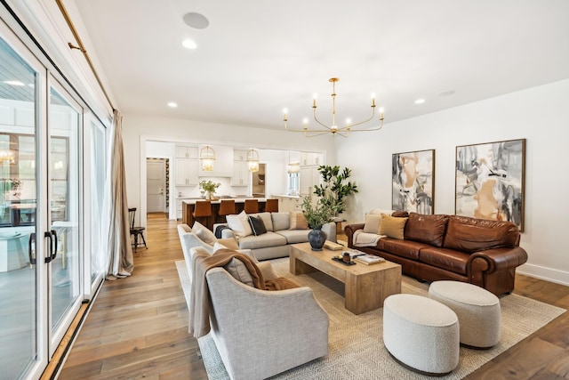 6490 Peytonsville Arno Rd, College Grove, TN 37046 - living area featuring light wood-style flooring, an inviting chandelier, recessed lighting, and a healthy amount of sunlight
