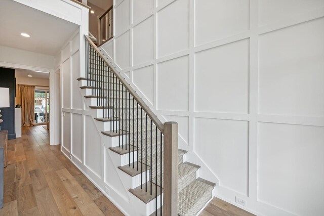 6490 Peytonsville Arno Rd, College Grove, TN 37046 - stairway featuring wood finished floors, recessed lighting, and a decorative wall
