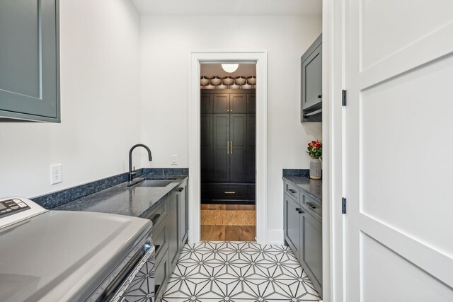 6490 Peytonsville Arno Rd, College Grove, TN 37046 - laundry room with light tile patterned floors, washer / clothes dryer, a sink, and cabinet space