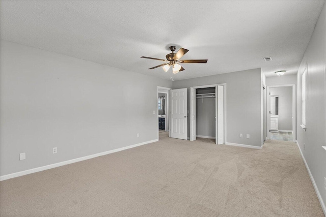 unfurnished bedroom with light carpet, baseboards, and ceiling fan