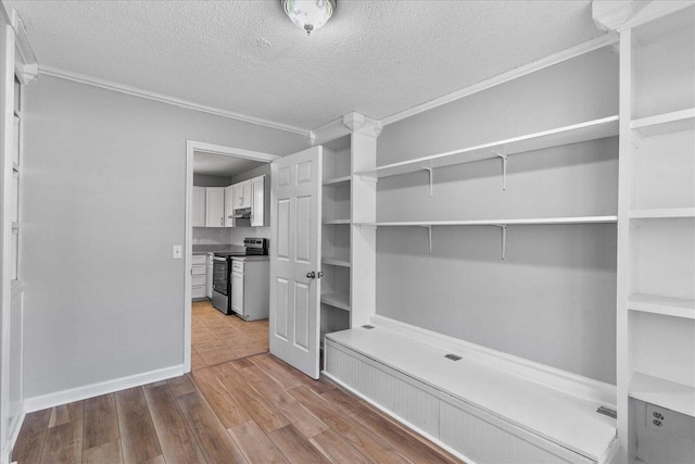 mudroom featuring crown molding, a textured ceiling, wood finished floors, and baseboards