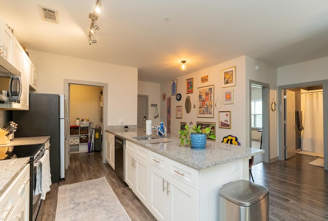 782 Riverfront Pkwy Unit 301, Chattanooga, TN 37402 - kitchen with a sink, stainless steel appliances, dark wood finished floors, a peninsula, and visible vents