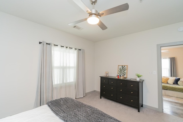 782 Riverfront Pkwy Unit 301, Chattanooga, TN 37402 - bedroom with visible vents, a ceiling fan, baseboards, and light carpet