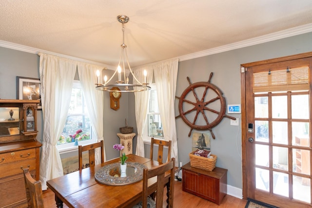 314 Williams Dr, Chattanooga, TN 37421 - dining area featuring light wood-type flooring, baseboards, a notable chandelier, and ornamental molding