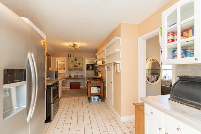 314 Williams Dr, Chattanooga, TN 37421 - kitchen featuring decorative backsplash, stainless steel appliances, and a fireplace
