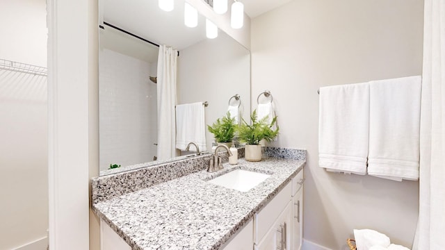 full bath with vanity and a shower