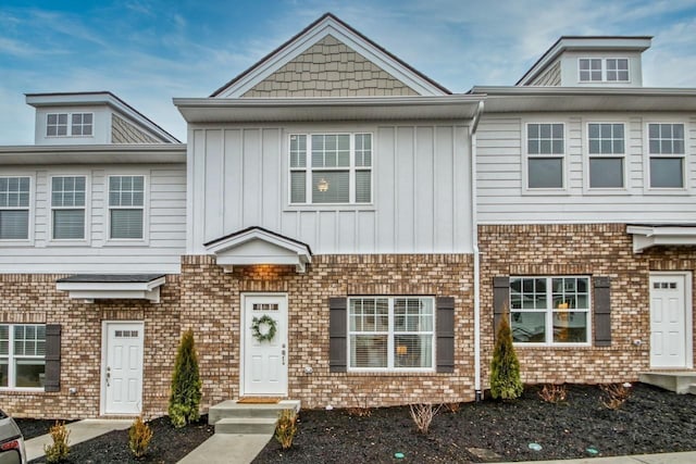 townhome / multi-family property featuring board and batten siding and brick siding